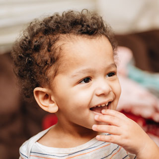 happy-diverse-toddler-boy-with-curly-hair-looking-2024-11-01-02-32-53-utc-web